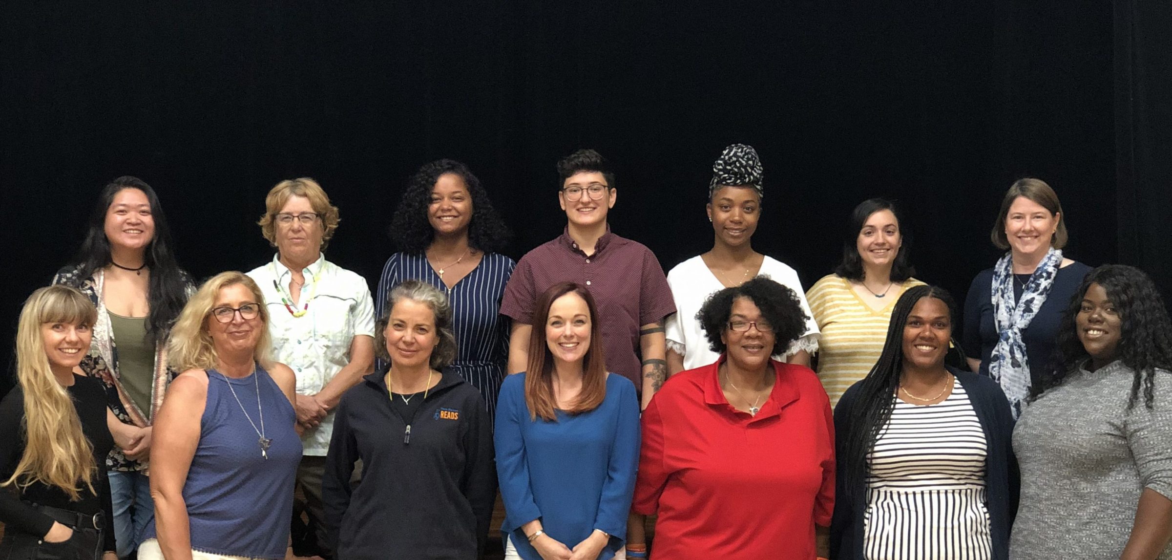 New Haven Reads staff members pose in front of stage during 2019 retreat.