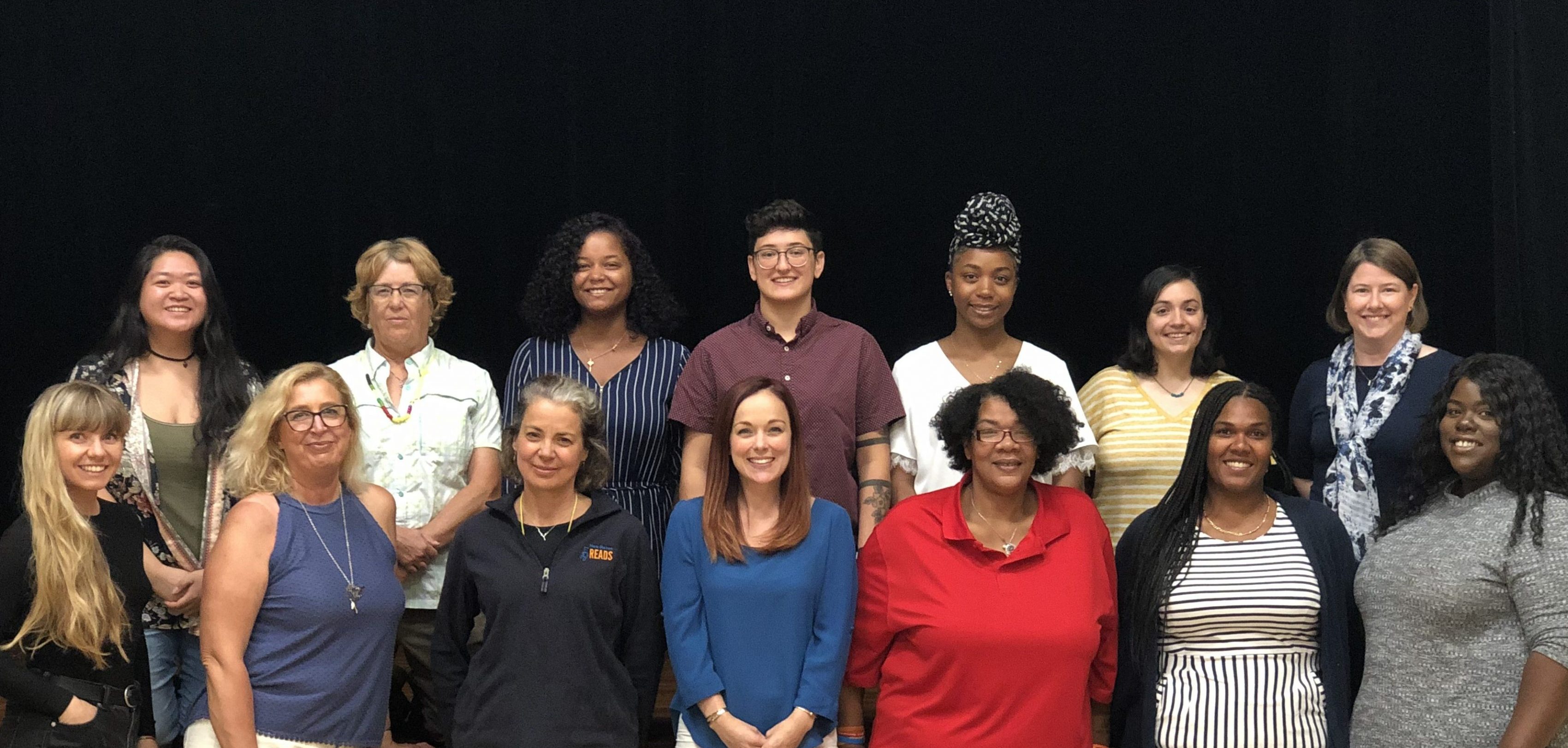 New Haven Reads staff members pose in front of stage during 2019 retreat.